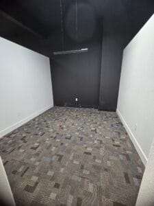Grey and black square-patterned commercial carpet installed in an office setting