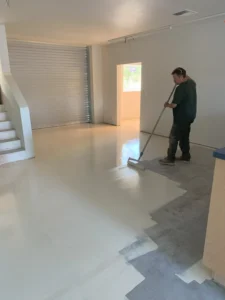 Walt applying paint to concrete floor during a commercial flooring project