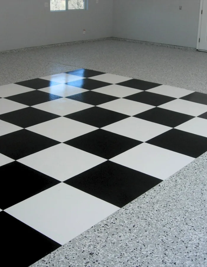 Empty room with a large black-and-white checkerboard tile area on the floor.